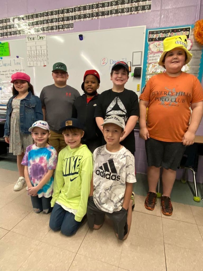 Eight students wearing hats.